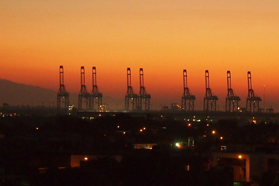 A battery of container cranes at dawn