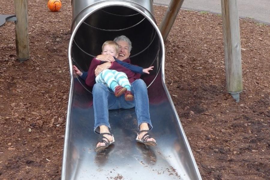 Jo and Conall ride the slide together