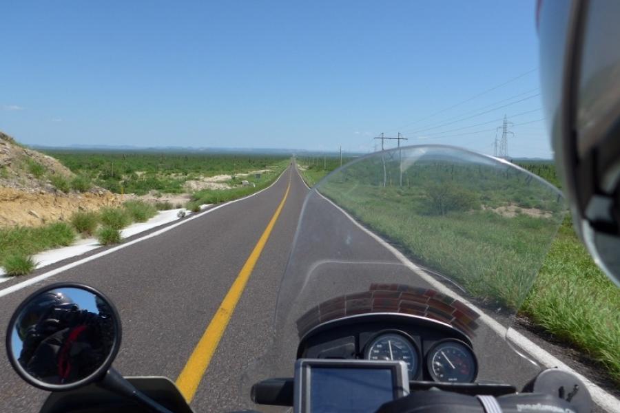 A straight road across a hot desert