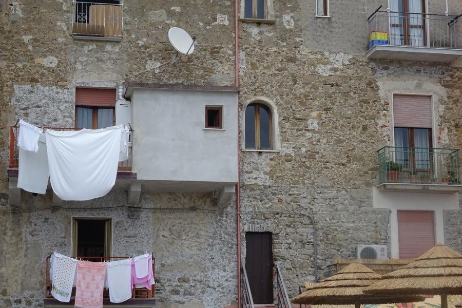 washing hanging out to dry in the wind, pretty hilltop village