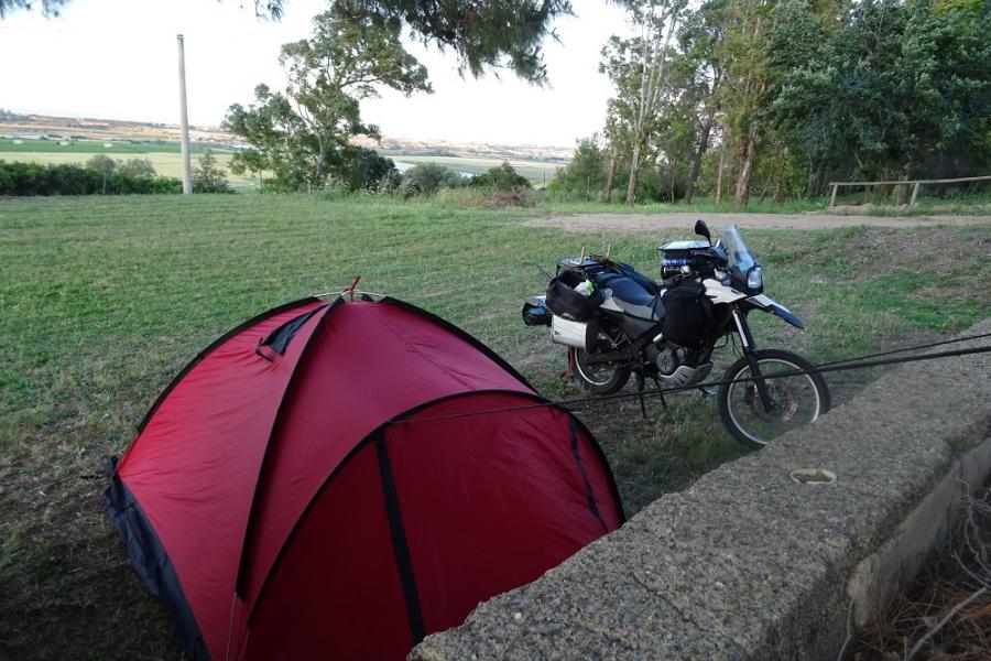 tent in garden tied to tree and disused caravan