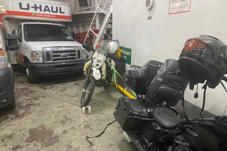 The BEAST tied down on the vehicle deck of the COLUMBIA with a friendly Harley for Company