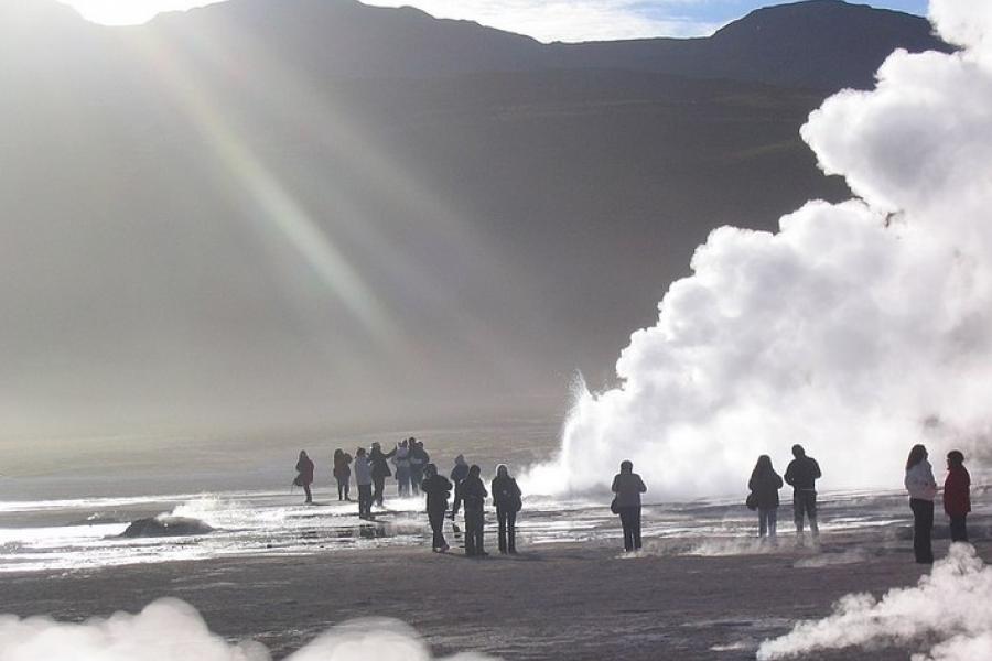 Visitors walking among steaming geysers, El Tatio Geysers