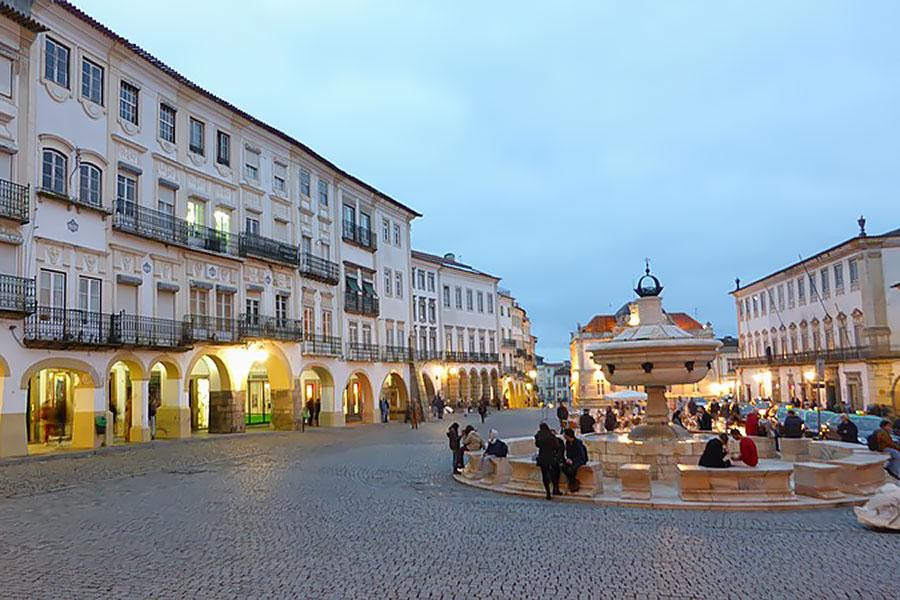 Balmy dusk in a cobblestone public square, Evora, Portugal