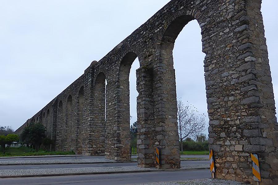 Stone archways above roads, Evora, Portugal