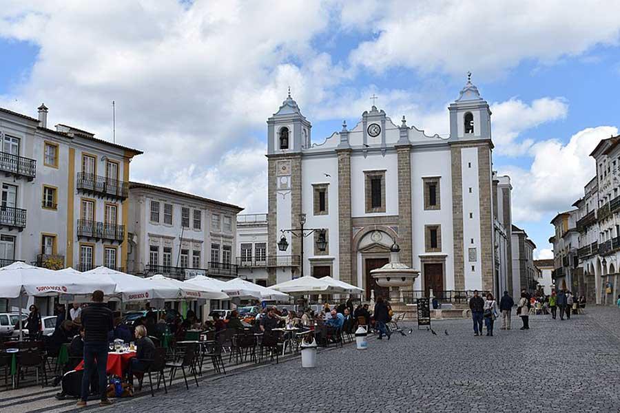 Dining outdoors in a cobblestone square, Evora, Portugal