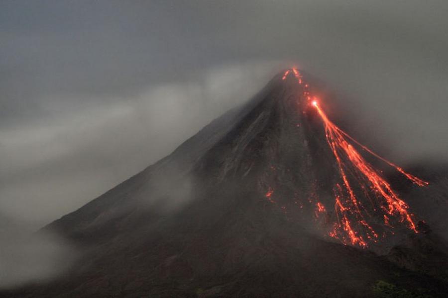 Night view of lava flowing down Arenal Volcano