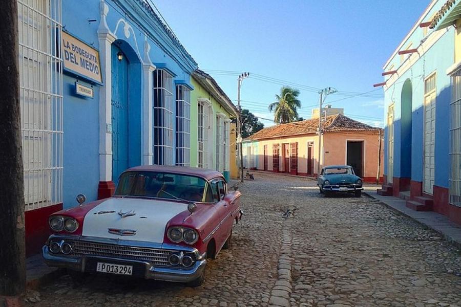 Vintage cars parked on cobblestone street, Trinidad, Cuba