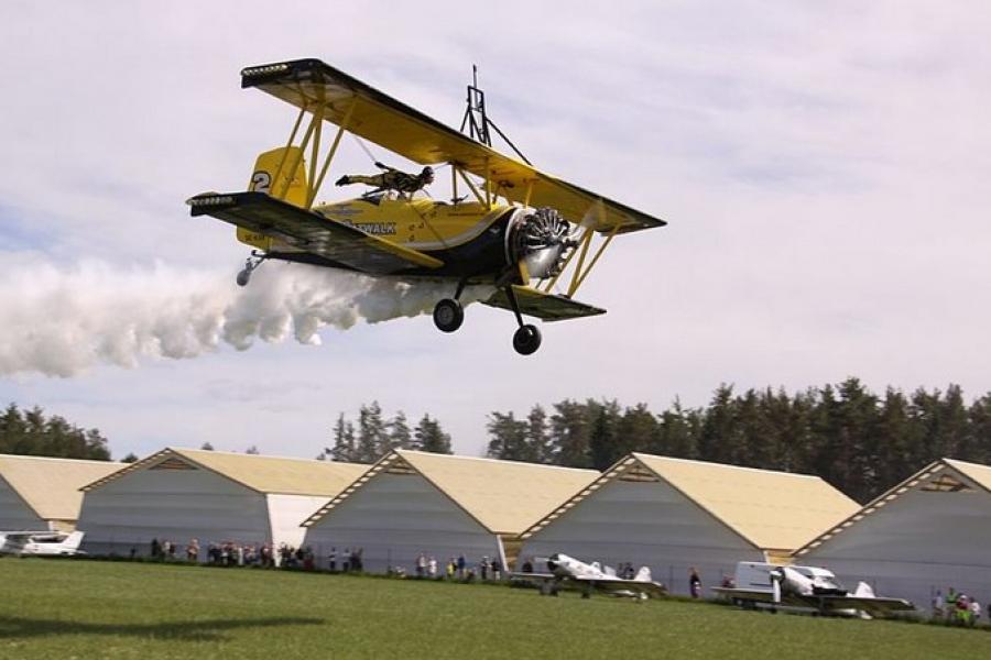 Low fly-by of stuntperson on bi-plane, Estonian Aviation Museum