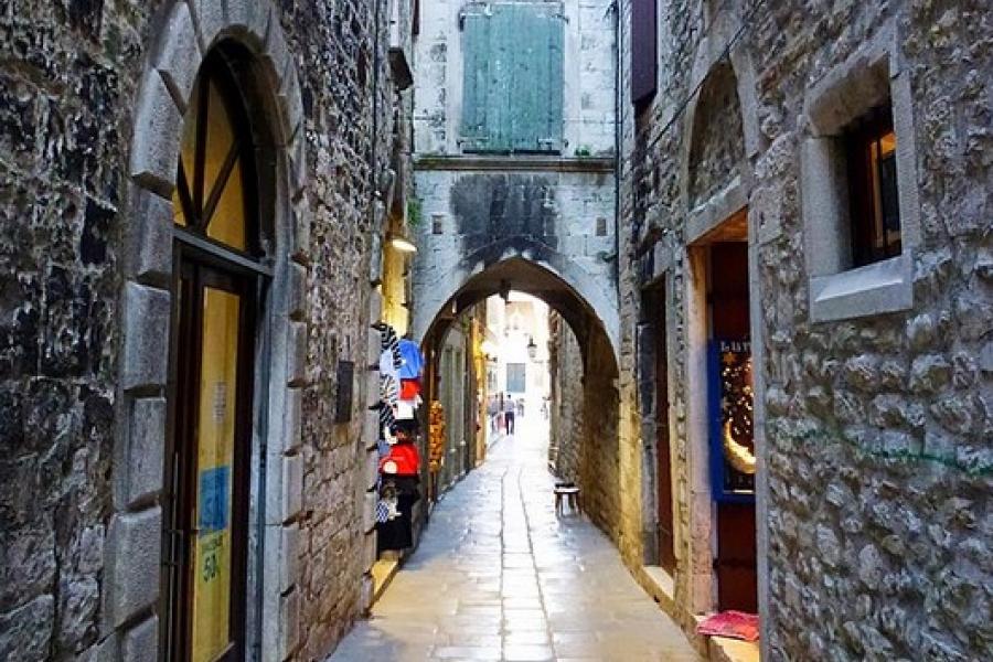 Narrow sidestreet with cobblestone and stone buildings, Split, Croatia