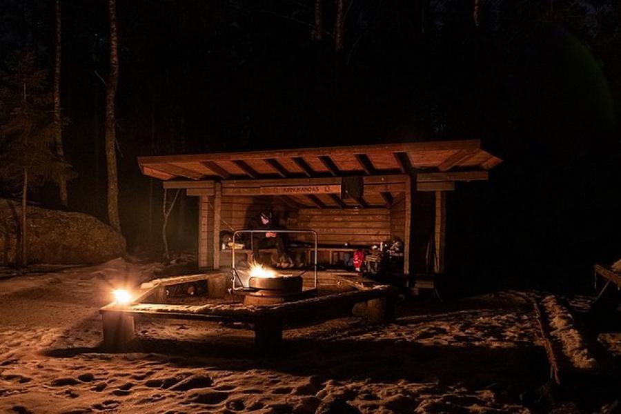 Enjoying a campfire night at a hut in Repovesi National Park