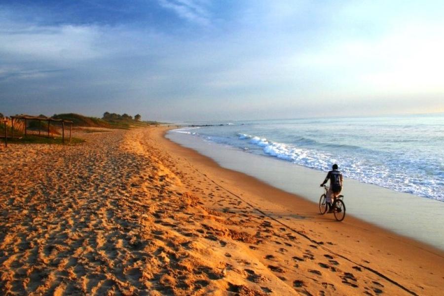 Cyclist on the beach, Gunjur Village