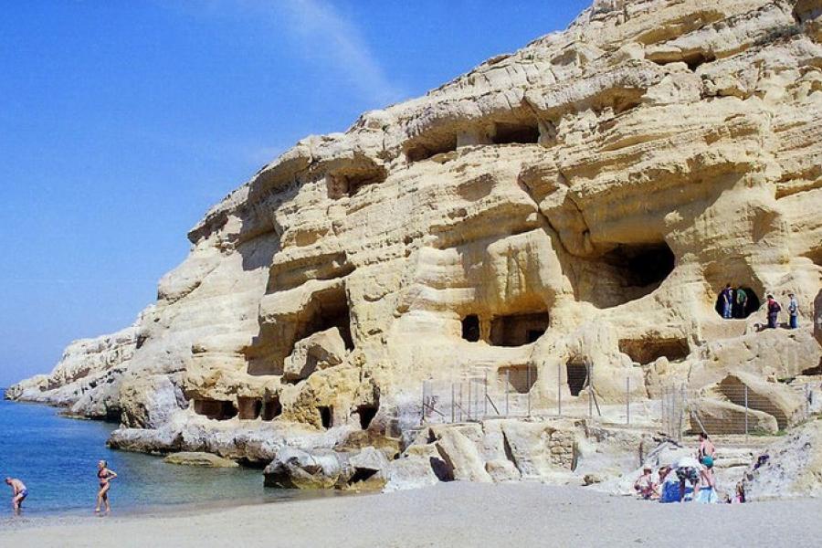 Visitors at cave openings of the Matala Caves, Greece