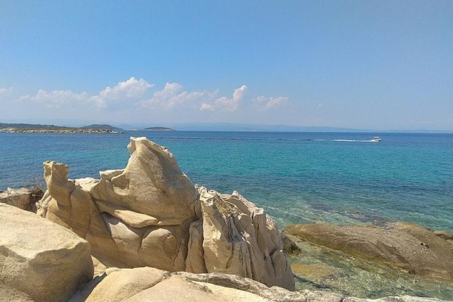 Rock formations and a passing boat, Sithonia Peninsula, Greece